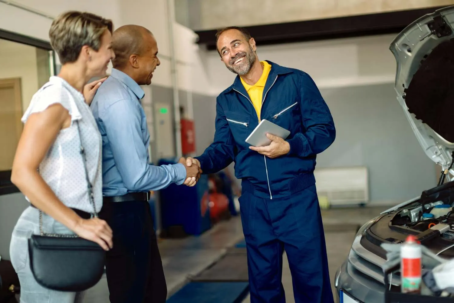Mechanic handshake with customers who are happy after taking our brake repair service in Kuwait.